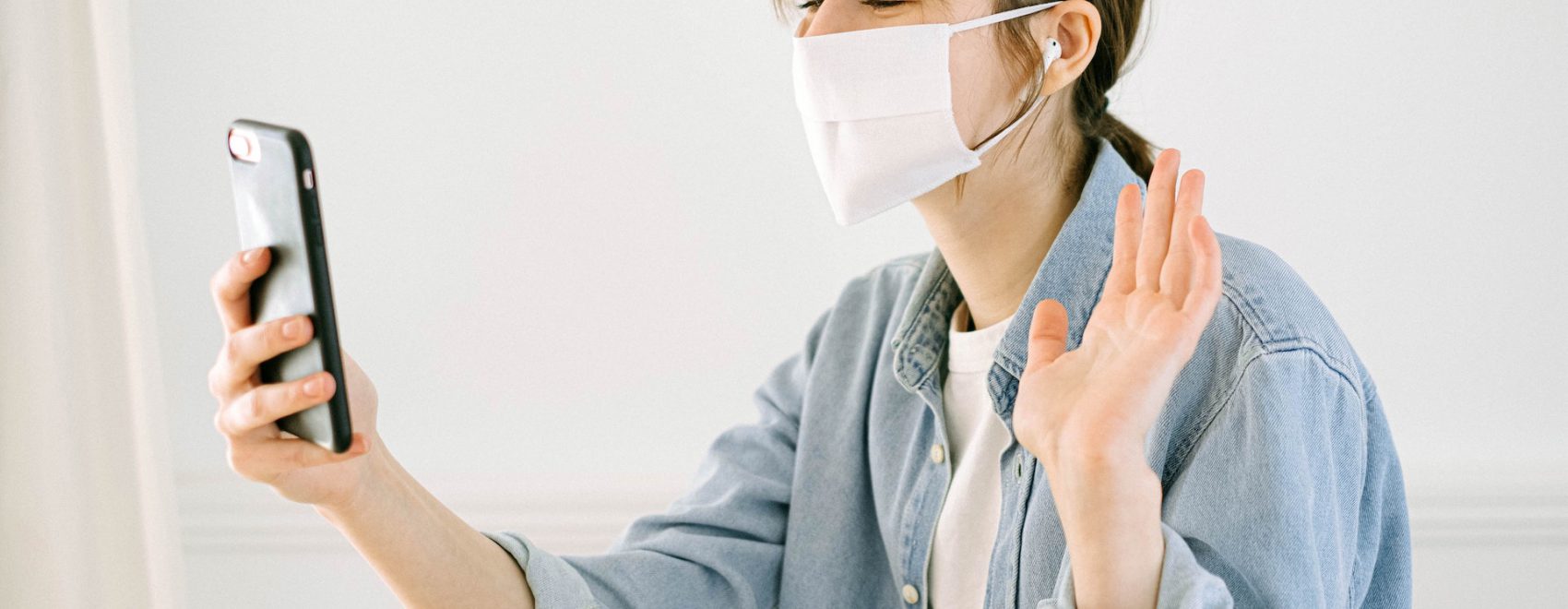 woman-in-face-mask-having-call